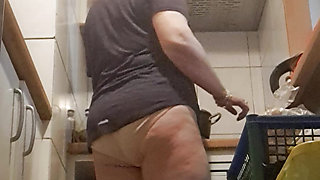 in the kitchen, relaxed, supported on her back