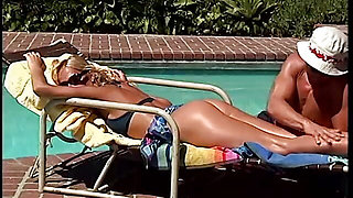 Hot blonde sucks a large cock at pool side
