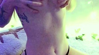 Young redhead in black panties poses seductively on webcam