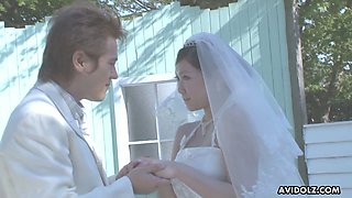 Naughty and quite buxom Japanese bride Emi Koizumi gives a good blowjob