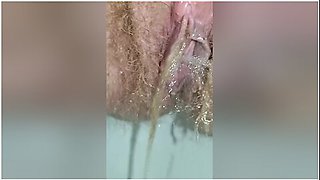 Detailed Close-up Footage Of A Hairy Pussy Girl Urinating From Her Pee Hole And Farting Loudly