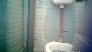 Pale skin brunette lady filmed from front side in the toilet