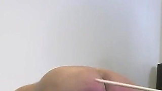 Young domme canes her slave