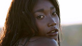 Petite Ebony MILF strips naked in a pool