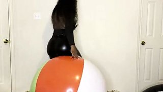 Ass bouncing on large beach ball before finger nail pop