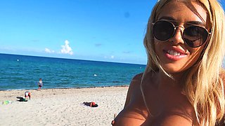 Blonde milf shows off her big tits and tight ass on the beach