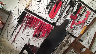 Lezdom chick punishing and whipping brunette chick