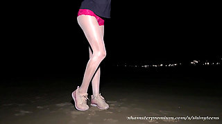 Anna in white shiny pantyhose on the night beach