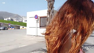 Cute redhead loves flashing her big perky tits in public