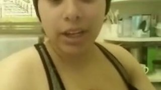 Busty latina squeezing milk out of her tit at home