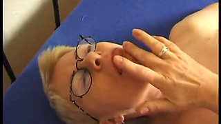 Mature caressing her body on the bed