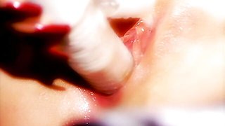 Glamorous doll with red lips Kitty Sixx plays with her shaved pussy