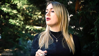 Hot Blonde Babe Smoking One Black Cigarettes in Nature