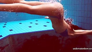 Skinny girl out in the pool cosplaying nirvana album cover underwater