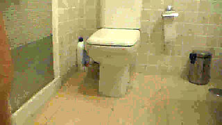 Jen is sitting on the toilet and peeing on the floor