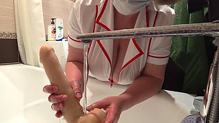 Big Boobs. Gorgeous Cleavage Under a Medical Gown. a Mature Nurse on Camera at Work