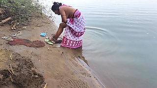 Indian village wife bathing in the river in outdoor area