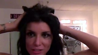Brunette with huge tits smiles in a dressing room