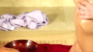 Alluring babe is blowing guy's cock in the bathroom