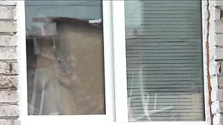 Naked in public. Random man taxi driver from car watches a naked woman washing apartment windows. Public nudity Naked woman  POV