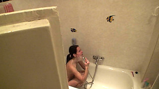 Sexy brunette teen is taking a shower