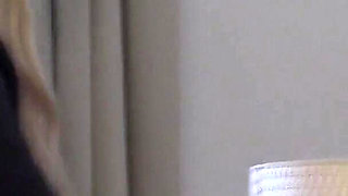 Blonde Babe Grips Purple Vibrator with Naughty Smile