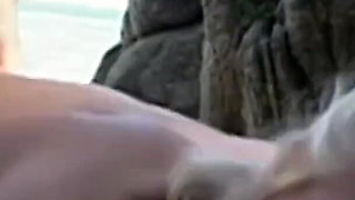 Horny couple fucking on the end of a beach