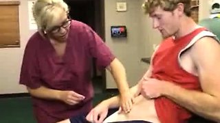 Milf Carey Riley strokes a young guys dick in the office